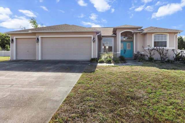 915 N Fox Meadow Ter, Crystal River, FL 34429 - view of front of house with stucco siding, an attached garage, driveway, and a front yard