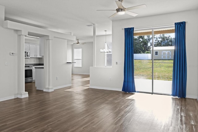 915 N Fox Meadow Ter, Crystal River, FL 34429 - unfurnished living room featuring a ceiling fan, dark wood-style floors, a chandelier, and baseboards