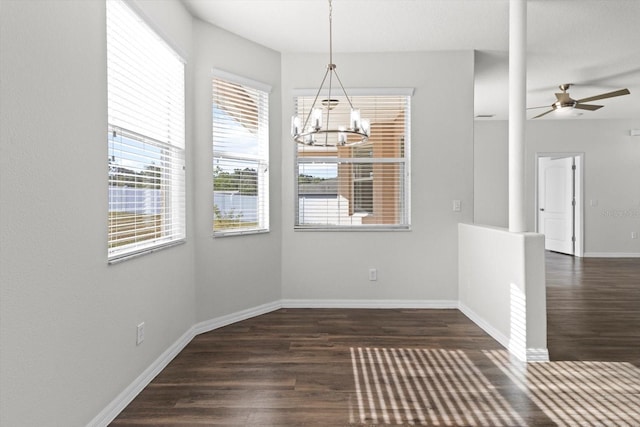 915 N Fox Meadow Ter, Crystal River, FL 34429 - unfurnished dining area featuring dark wood finished floors, a chandelier, baseboards, and a ceiling fan