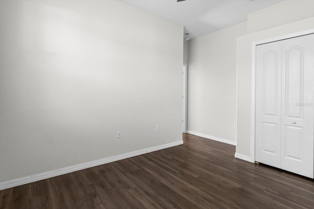 915 N Fox Meadow Ter, Crystal River, FL 34429 - unfurnished bedroom with dark wood-type flooring, a closet, baseboards, and a ceiling fan