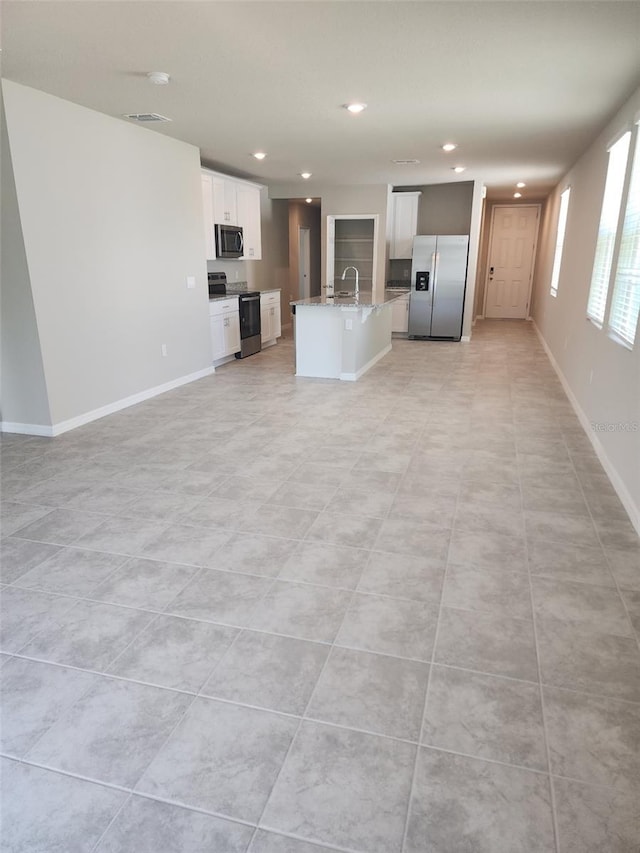 1808 Carnostie Rd, Winter Haven, FL 33884 - unfurnished living room with a sink, recessed lighting, and baseboards