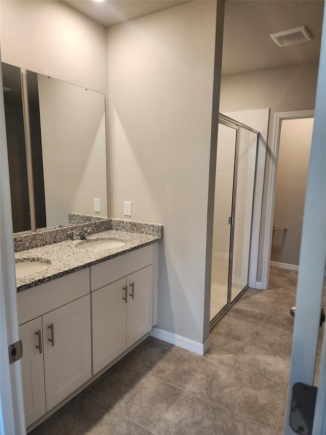 1808 Carnostie Rd, Winter Haven, FL 33884 - full bath with a stall shower, double vanity, and baseboards