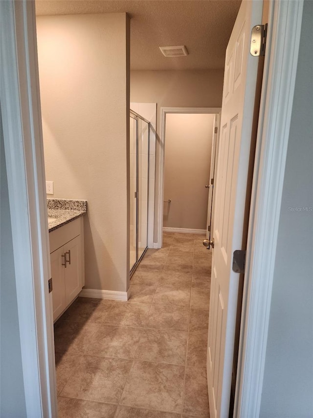 1808 Carnostie Rd, Winter Haven, FL 33884 - full bath with a stall shower, vanity, baseboards, a textured ceiling, and tile patterned flooring