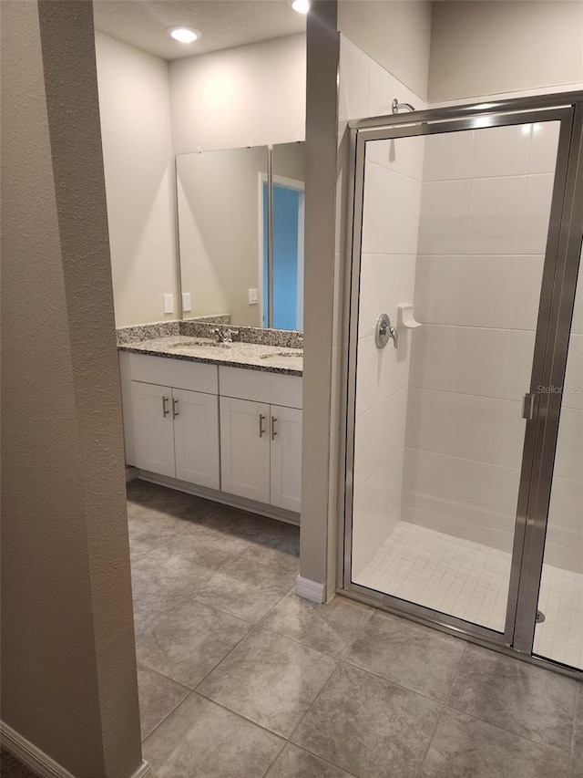 1808 Carnostie Rd, Winter Haven, FL 33884 - full bathroom featuring a stall shower, double vanity, tile patterned flooring, and recessed lighting