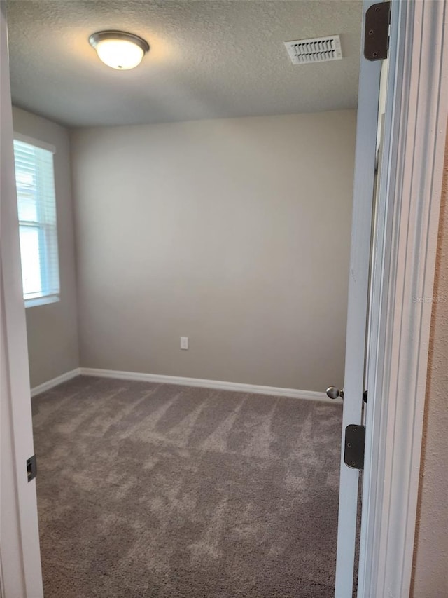 1808 Carnostie Rd, Winter Haven, FL 33884 - unfurnished room with carpet flooring, baseboards, and a textured ceiling