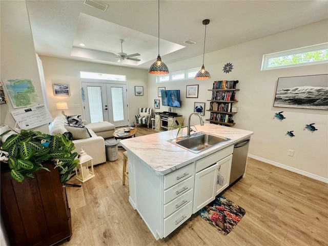 12077 Lakeshore Way, Oxford, FL 34484 - kitchen featuring a sink, a tray ceiling, dishwasher, light wood finished floors, and open floor plan