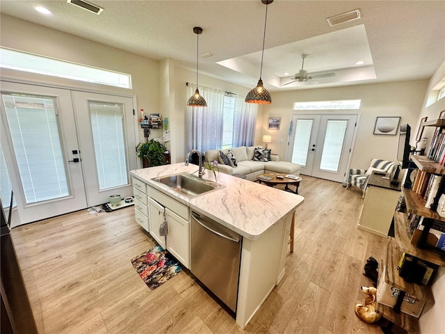 12077 Lakeshore Way, Oxford, FL 34484 - kitchen with french doors, dishwasher, a sink, a center island with sink, and light wood finished floors
