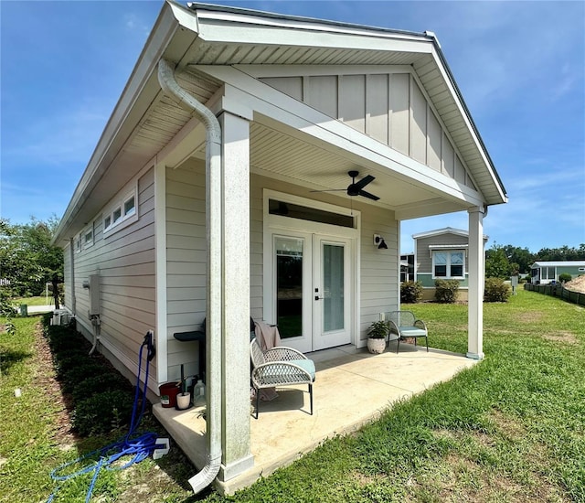 12077 Lakeshore Way, Oxford, FL 34484 - back of property featuring board and batten siding, a yard, ceiling fan, french doors, and a patio area