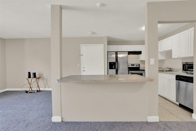 2423 Branch Way Unit 207, Maitland, FL 32751 - kitchen featuring stainless steel appliances, exhaust hood, white cabinetry, a sink, and light countertops