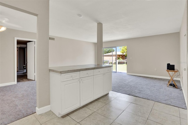 2423 Branch Way Unit 207, Maitland, FL 32751 - kitchen featuring light carpet, open floor plan, white cabinetry, baseboards, and light tile patterned flooring