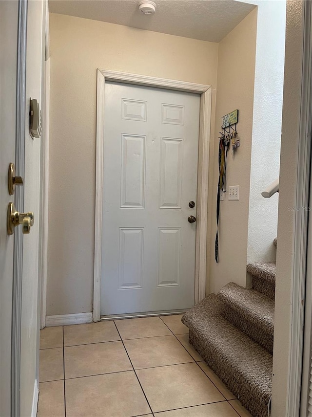 206 Orchid Dr, Davenport, FL 33897 - foyer with light tile patterned flooring and stairs