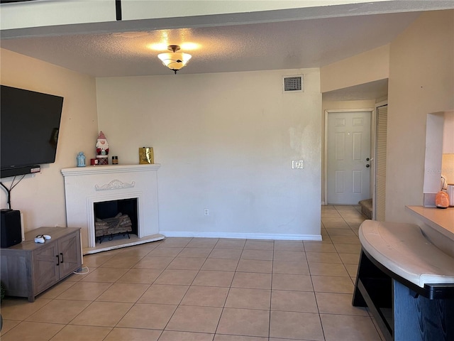 206 Orchid Dr, Davenport, FL 33897 - living room with light tile patterned flooring, a fireplace with raised hearth, and baseboards