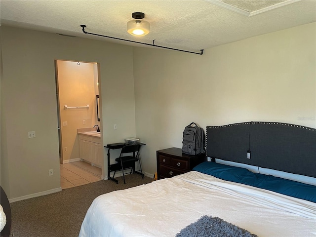 206 Orchid Dr, Davenport, FL 33897 - bedroom with light colored carpet, a textured ceiling, ensuite bath, light tile patterned floors, and baseboards