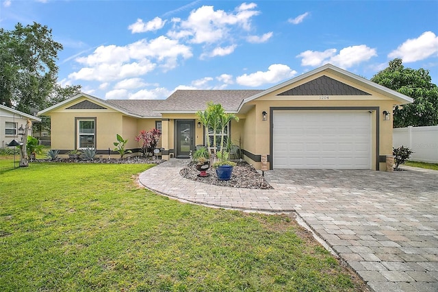 1204 Monterey Dr, Eustis, FL 32726 - ranch-style home featuring decorative driveway, stucco siding, and an attached garage