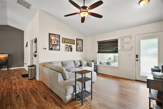 1204 Monterey Dr, Eustis, FL 32726 - living room with lofted ceiling, a ceiling fan, wood finished floors, and baseboards