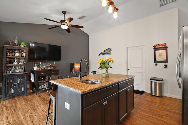 1204 Monterey Dr, Eustis, FL 32726 - kitchen featuring freestanding refrigerator, a sink, light wood-type flooring, ceiling fan, and lofted ceiling