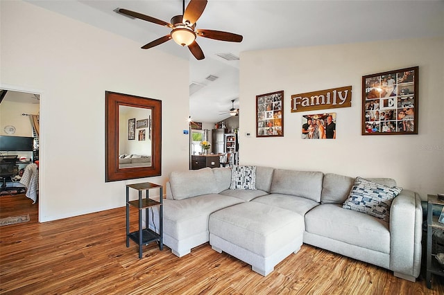 1204 Monterey Dr, Eustis, FL 32726 - living area with ceiling fan, wood finished floors, and vaulted ceiling