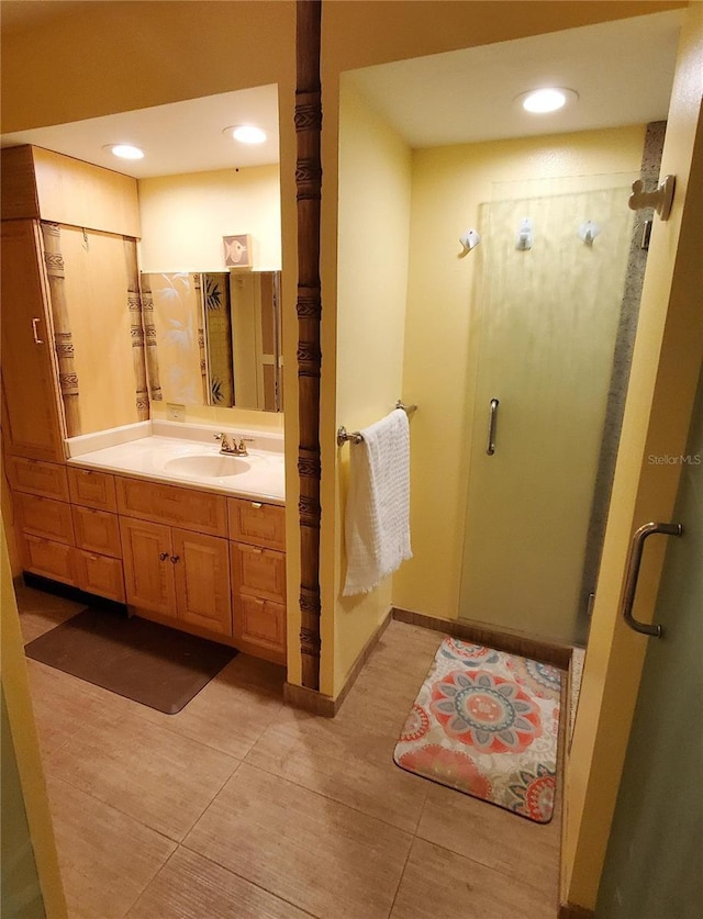 632 Edgewater Dr Unit 832, Dunedin, FL 34698 - bathroom with vanity, a shower stall, tile patterned floors, and recessed lighting
