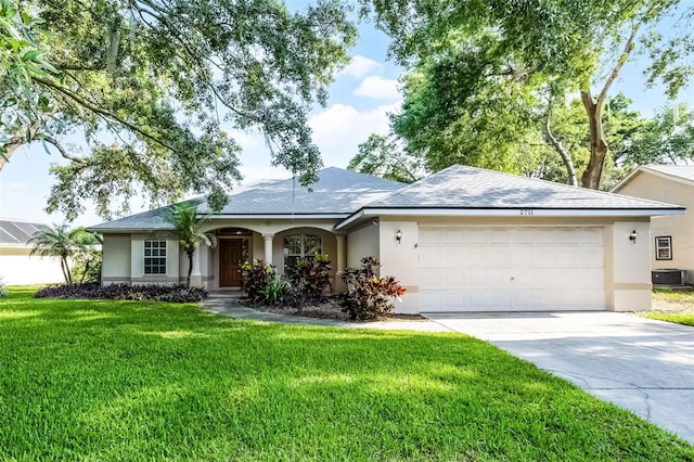 2711 Bayview Dr, Eustis, FL 32726 - single story home featuring stucco siding, a garage, central AC unit, and driveway