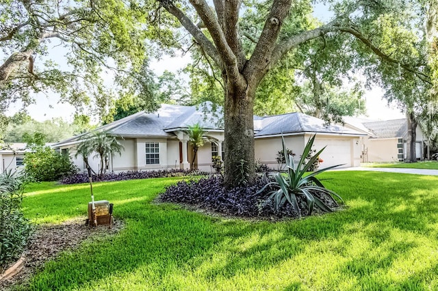 2711 Bayview Dr, Eustis, FL 32726 - ranch-style house featuring stucco siding, a garage, a front lawn, and driveway