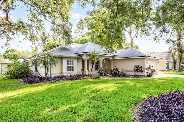 2711 Bayview Dr, Eustis, FL 32726 - ranch-style house featuring stucco siding, a garage, a front yard, and driveway