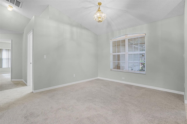 2711 Bayview Dr, Eustis, FL 32726 - empty room with vaulted ceiling, carpet flooring, a chandelier, baseboards, and a textured ceiling