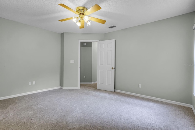 2711 Bayview Dr, Eustis, FL 32726 - unfurnished bedroom with carpet floors, baseboards, a textured ceiling, and ceiling fan