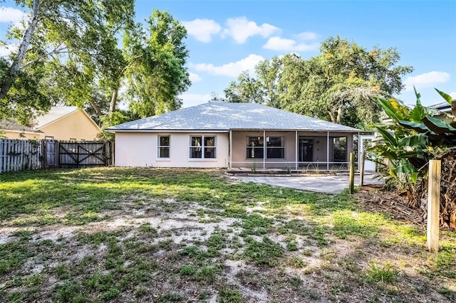 2711 Bayview Dr, Eustis, FL 32726 - rear view of house with a gate, a sunroom, stucco siding, and a patio