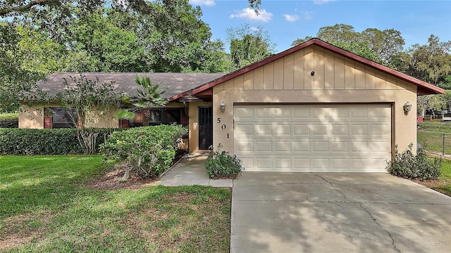 501 Cherry Tree St, Eustis, FL 32726 - ranch-style house featuring a garage, concrete driveway, and a front yard