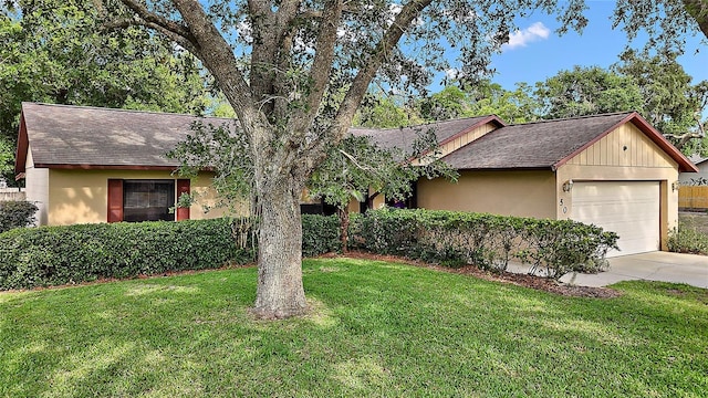 501 Cherry Tree St, Eustis, FL 32726 - ranch-style home with a garage, a shingled roof, a front yard, driveway, and stucco siding