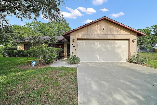 501 Cherry Tree St, Eustis, FL 32726 - ranch-style house featuring concrete driveway and an attached garage
