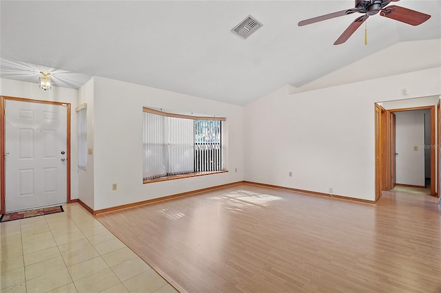 501 Cherry Tree St, Eustis, FL 32726 - empty room with vaulted ceiling, ceiling fan, baseboards, and light wood-type flooring
