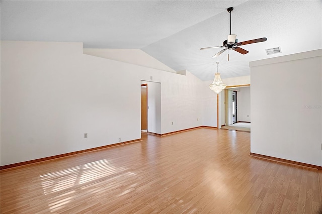 501 Cherry Tree St, Eustis, FL 32726 - empty room featuring vaulted ceiling, a ceiling fan, light wood-style flooring, a chandelier, and baseboards