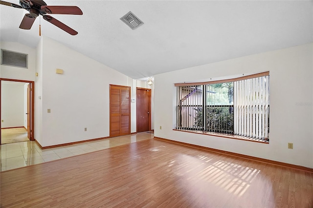 501 Cherry Tree St, Eustis, FL 32726 - spare room with ceiling fan, baseboards, light wood finished floors, and high vaulted ceiling