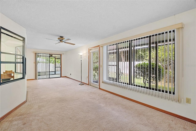 501 Cherry Tree St, Eustis, FL 32726 - carpeted empty room with baseboards, ceiling fan, and a textured ceiling