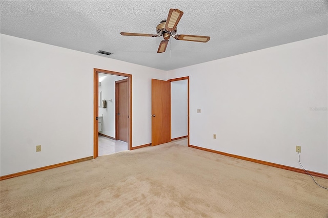 501 Cherry Tree St, Eustis, FL 32726 - unfurnished room featuring light carpet, ceiling fan, baseboards, and a textured ceiling