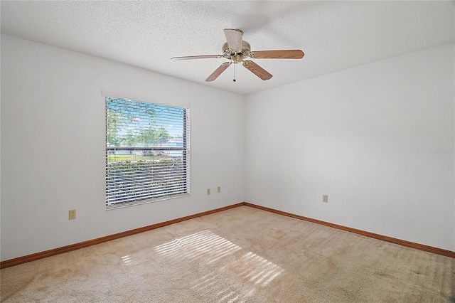 501 Cherry Tree St, Eustis, FL 32726 - unfurnished room featuring light carpet, a ceiling fan, baseboards, and a textured ceiling