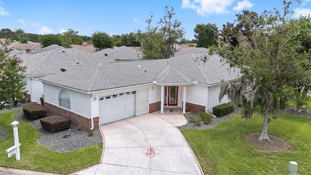 8608 SE 141st Street Rd, Summerfield, FL 34491 - single story home featuring brick siding, concrete driveway, a garage, a front lawn, and roof with shingles