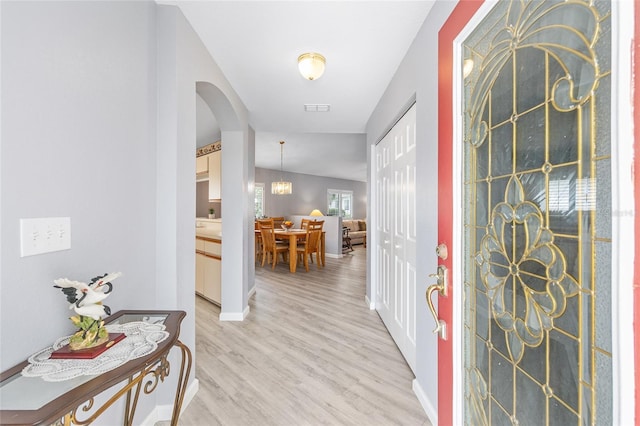 8608 SE 141st Street Rd, Summerfield, FL 34491 - foyer entrance featuring light wood-style floors, arched walkways, and baseboards