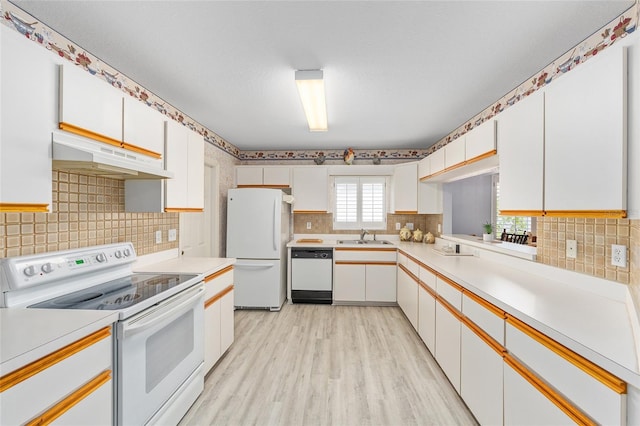 8608 SE 141st Street Rd, Summerfield, FL 34491 - kitchen featuring white appliances, under cabinet range hood, a sink, light countertops, and decorative backsplash