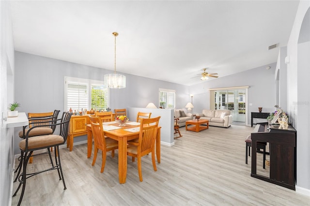 8608 SE 141st Street Rd, Summerfield, FL 34491 - dining room with light wood finished floors, ceiling fan, a chandelier, plenty of natural light, and lofted ceiling