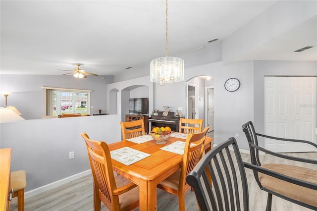 8608 SE 141st Street Rd, Summerfield, FL 34491 - dining area featuring arched walkways, a ceiling fan, light wood-type flooring, and baseboards