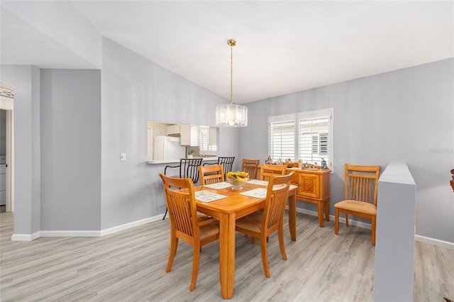 8608 SE 141st Street Rd, Summerfield, FL 34491 - dining space with light wood finished floors, baseboards, a chandelier, and vaulted ceiling