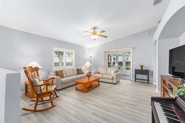 8608 SE 141st Street Rd, Summerfield, FL 34491 - living room with arched walkways, ceiling fan, light wood-type flooring, baseboards, and vaulted ceiling