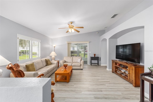 8608 SE 141st Street Rd, Summerfield, FL 34491 - living area with lofted ceiling, plenty of natural light, light wood finished floors, a ceiling fan, and arched walkways