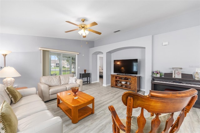 8608 SE 141st Street Rd, Summerfield, FL 34491 - living room featuring arched walkways, ceiling fan, light wood finished floors, and baseboards