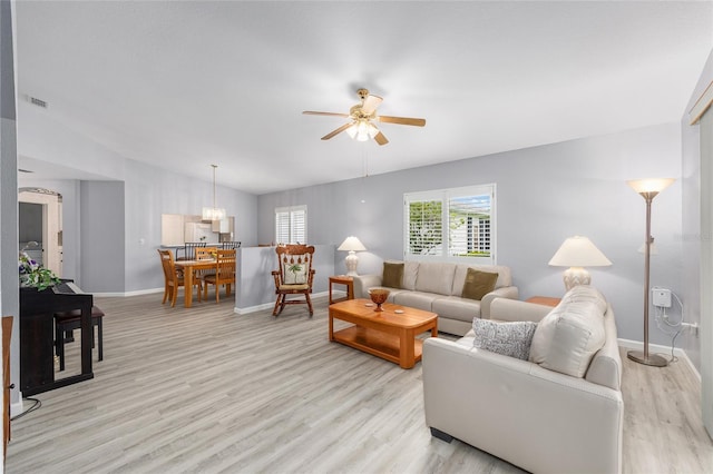 8608 SE 141st Street Rd, Summerfield, FL 34491 - living area with ceiling fan, light wood-style flooring, baseboards, and vaulted ceiling
