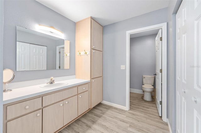 8608 SE 141st Street Rd, Summerfield, FL 34491 - bathroom with toilet, vanity, wood finished floors, and baseboards