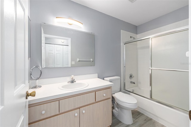 8608 SE 141st Street Rd, Summerfield, FL 34491 - bathroom featuring toilet, vanity, shower / bath combination with glass door, and wood finished floors