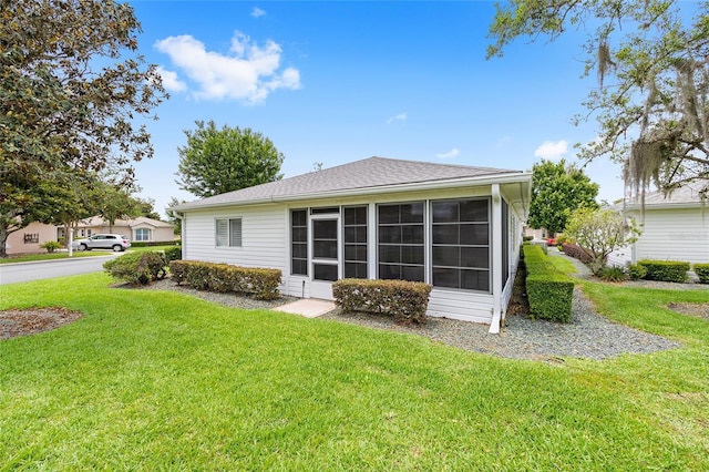 8608 SE 141st Street Rd, Summerfield, FL 34491 - back of house featuring a yard, a sunroom, and a shingled roof